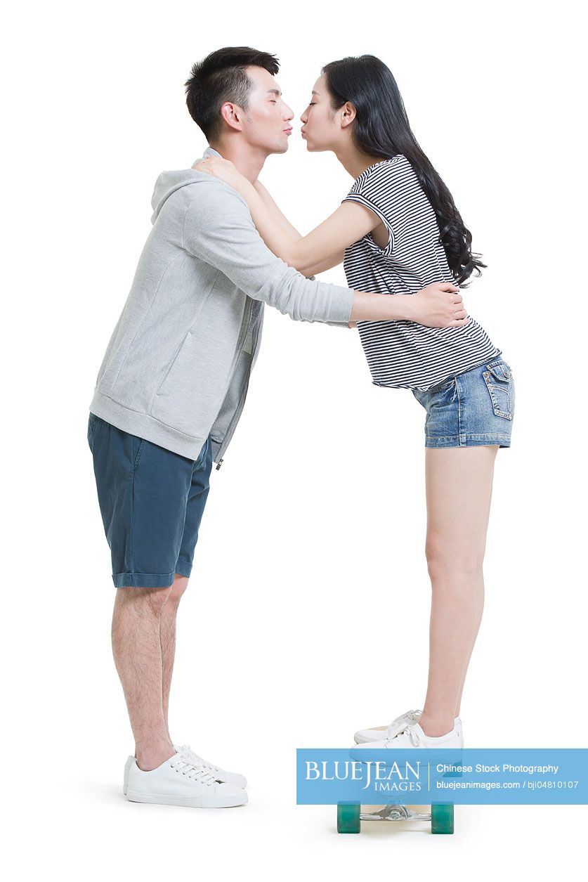 Happy young Chinese couple kissing
