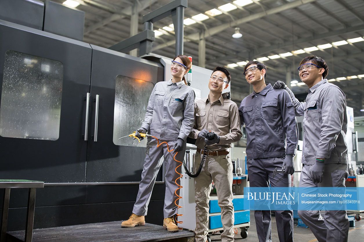 Confident Chinese engineers in the factory