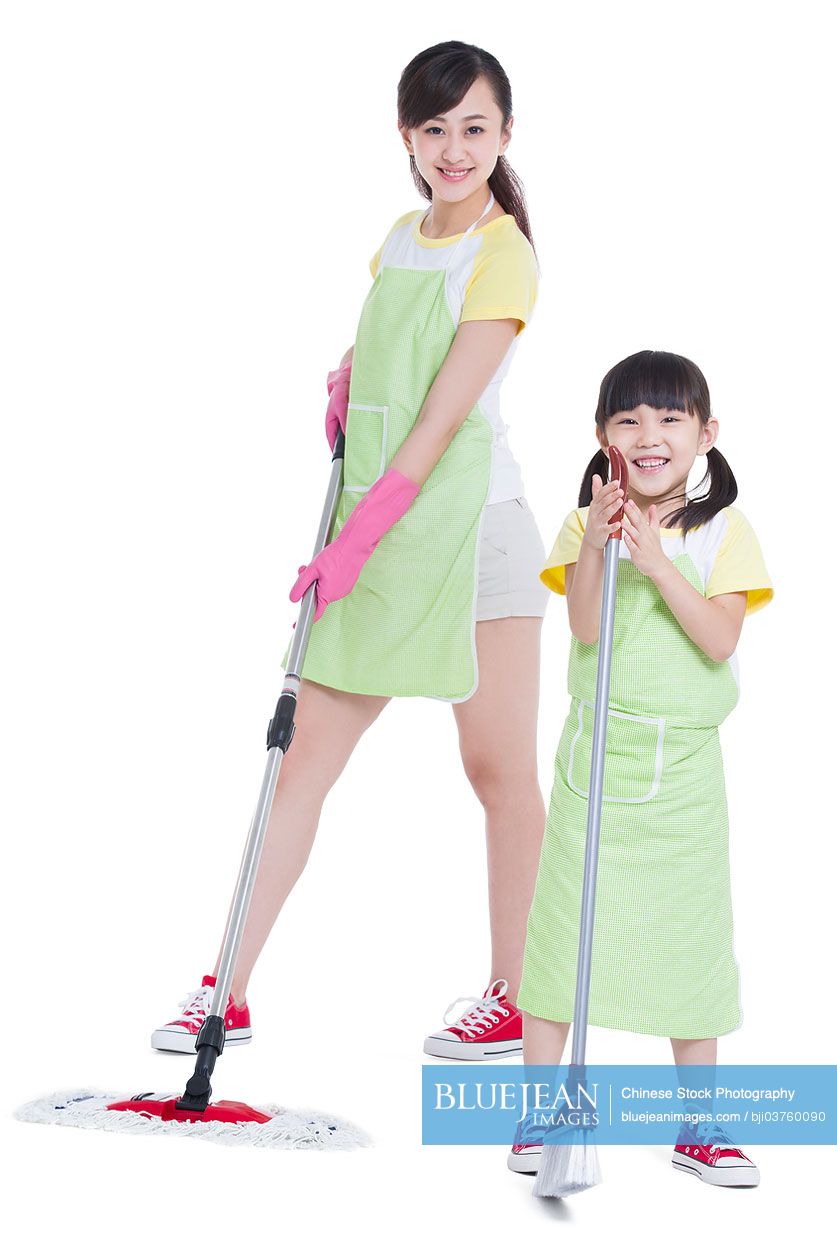 Happy Chinese mother and daughter cleaning the floor