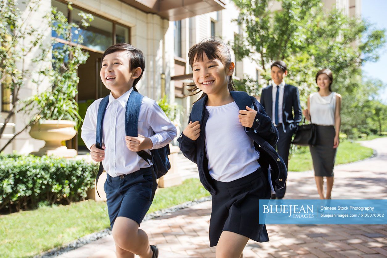 Happy Chinese sister and brother going to school