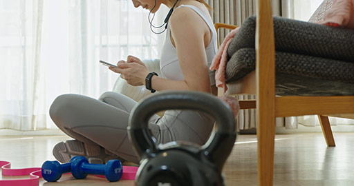 Young Chinese woman using smart phone after exercising,4K