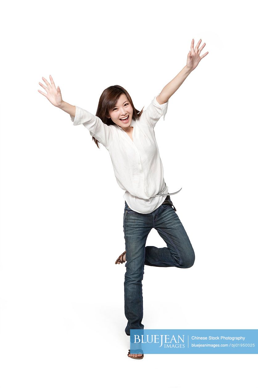 Portrait of young Chinese woman with arms outstretched