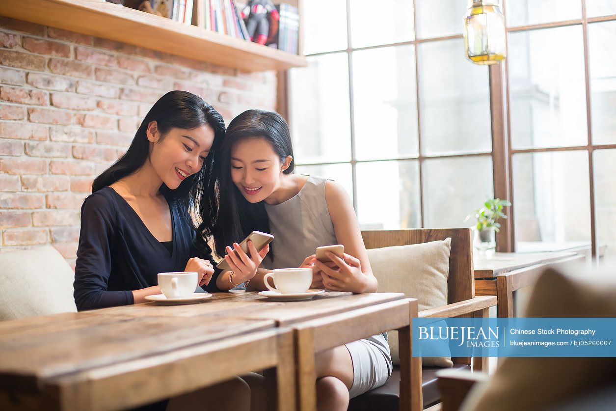 Best Chinese female friends drinking coffee in café