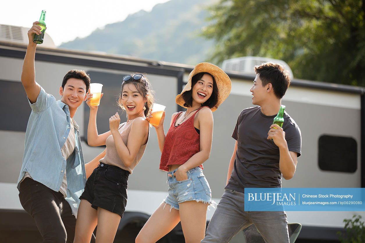 Happy young Chinese friends having fun outdoors