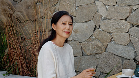 Elegant mature Chinese woman drinking tea in tea room,4K