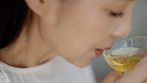 Elegant mature Chinese woman drinking tea in tea room,4K