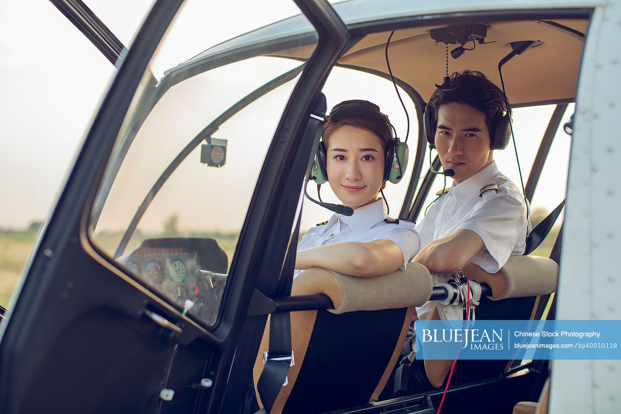 Chinese pilots sitting in helicopter cockpit