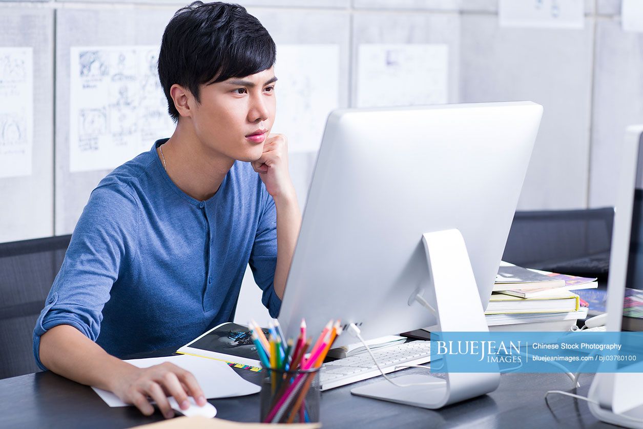 Young Chinese man working in the office