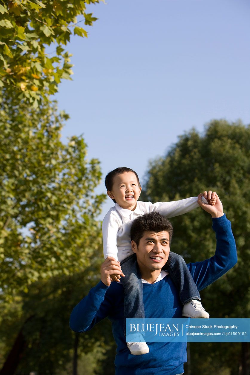 Portrait of Chinese father and son in the park