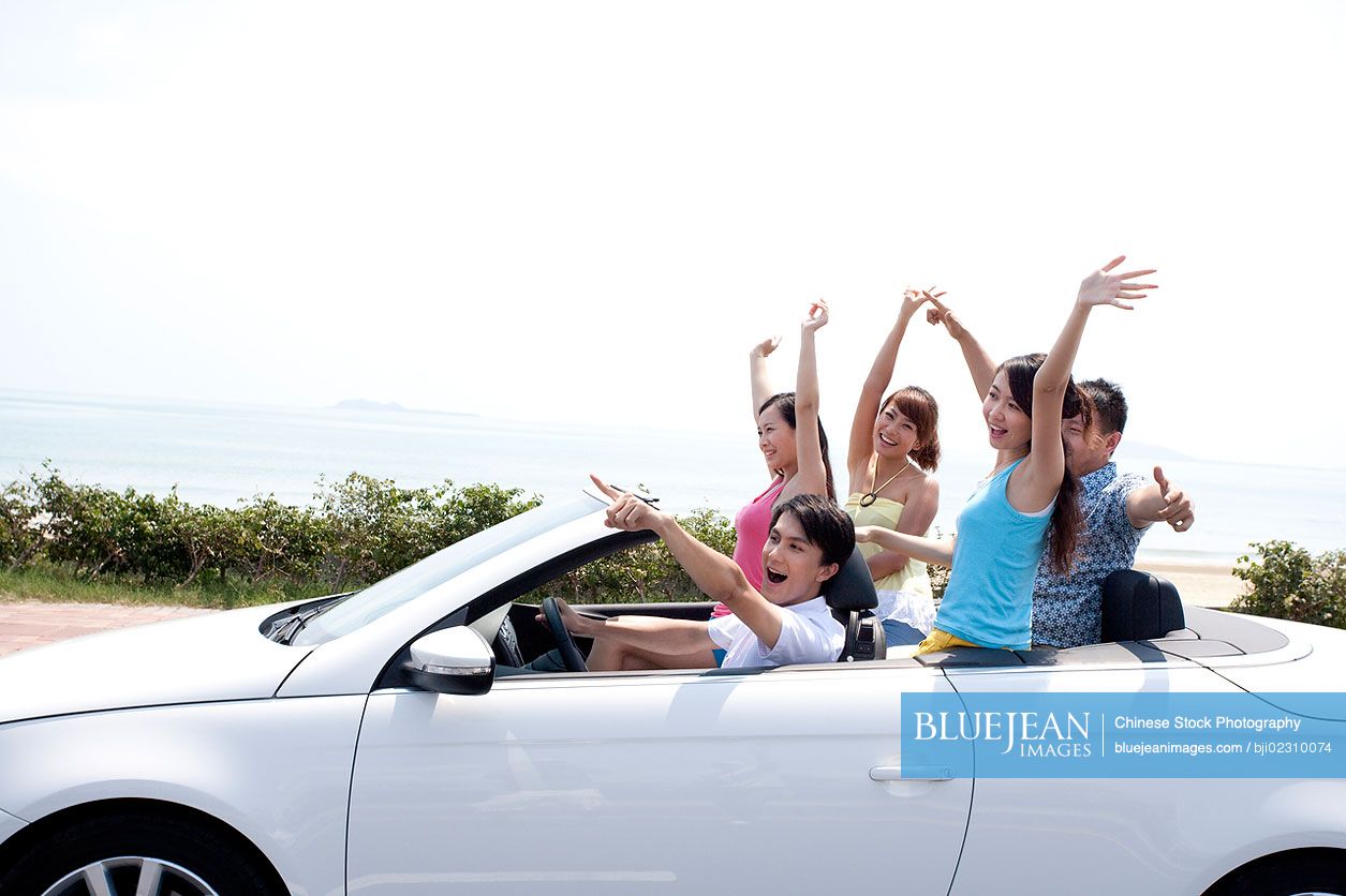Chinese friends having fun in a convertible
