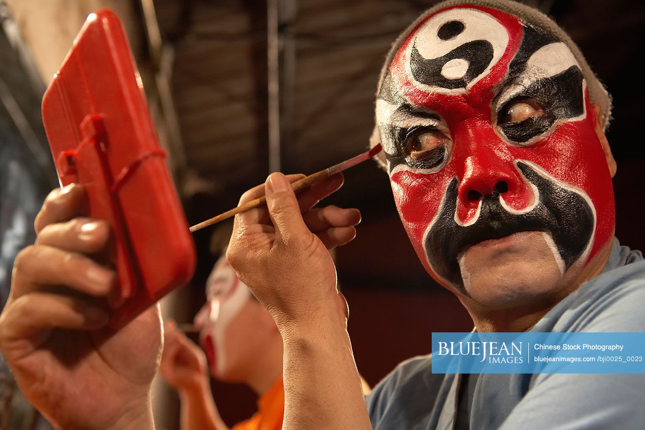Chinese Man Applying Traditional Face Paint