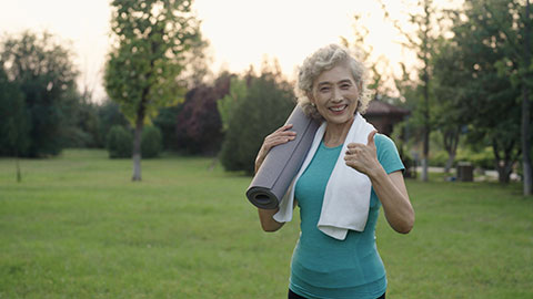 Happy senior Chinese woman exercising in park,4K