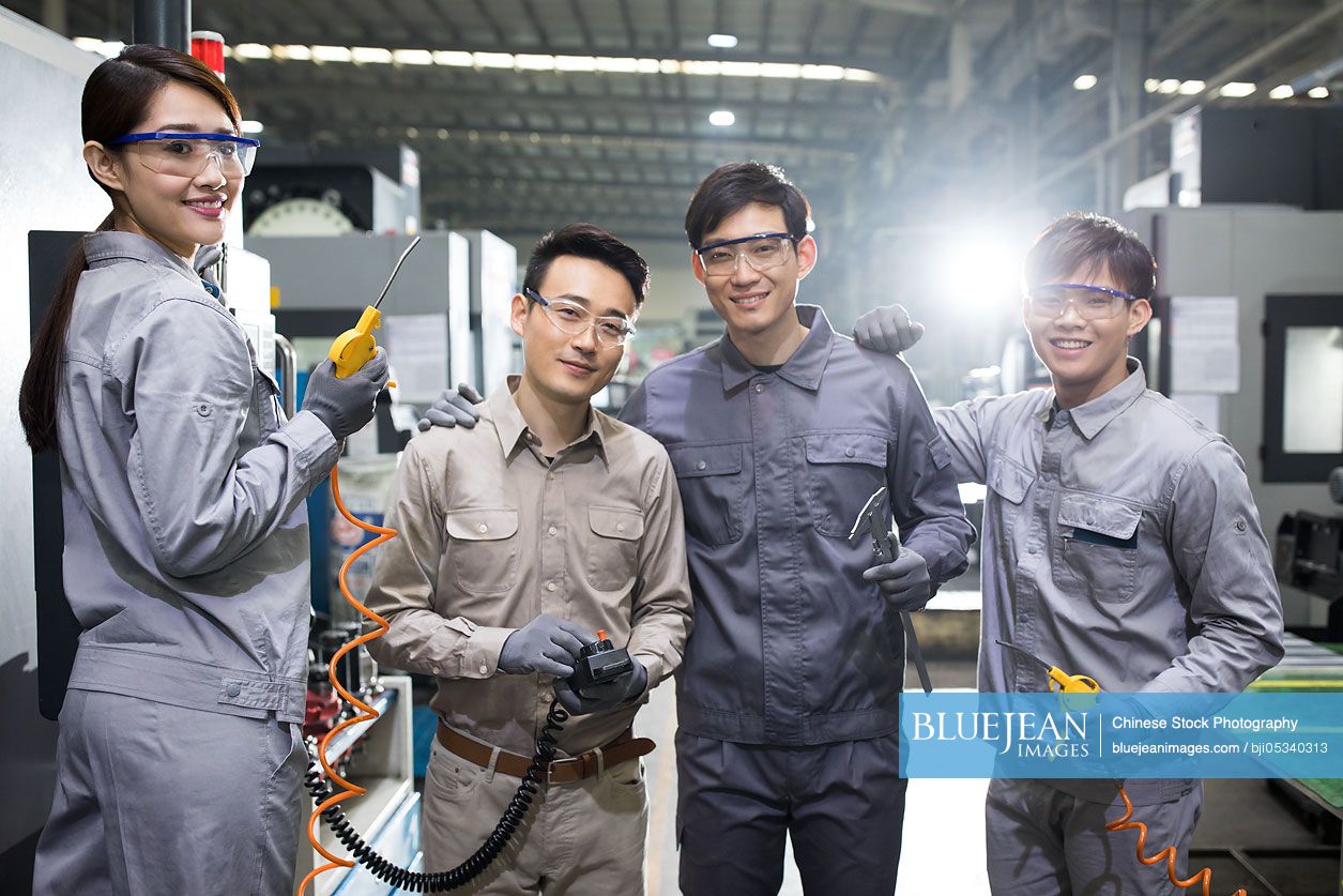 Confident Chinese engineers in the factory