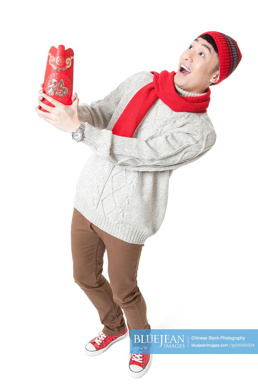 Funny young man enjoying Chinese New Year with red envelop