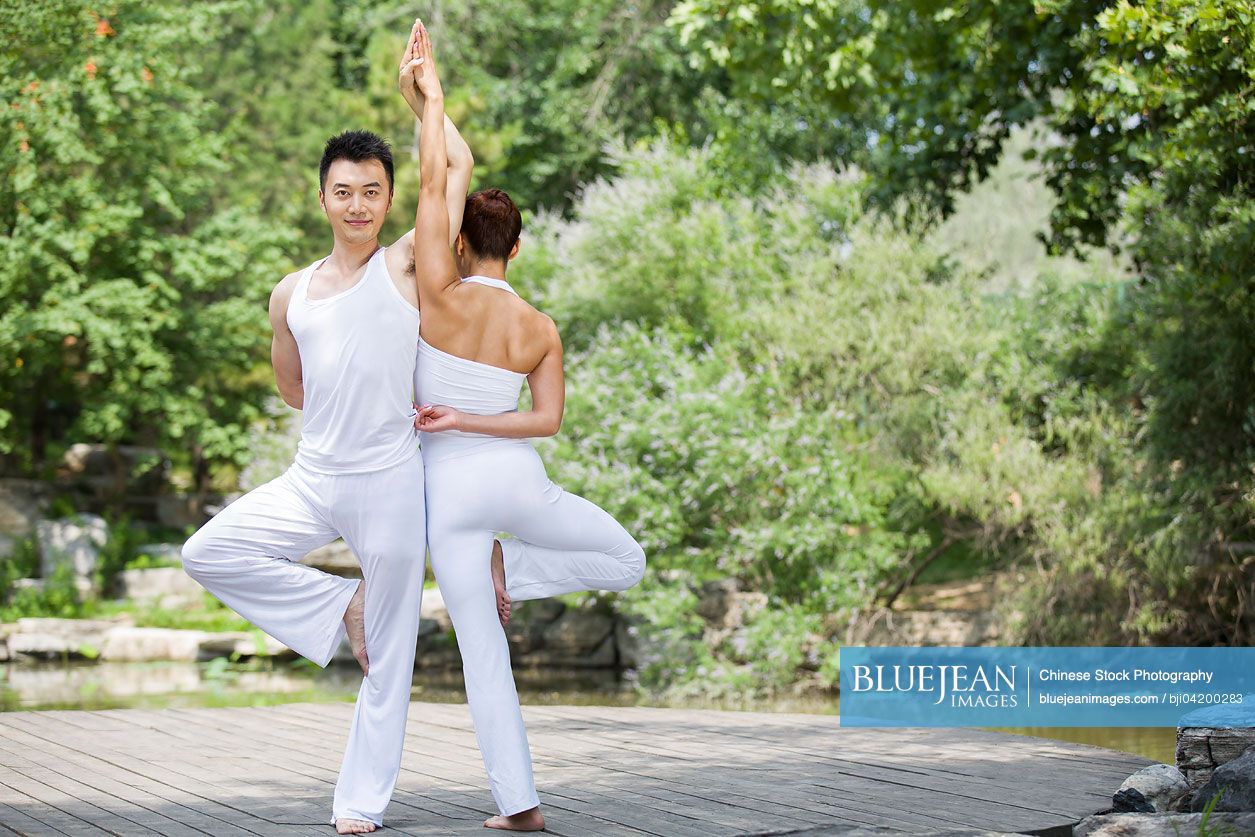 Young Chinese couple doing yoga