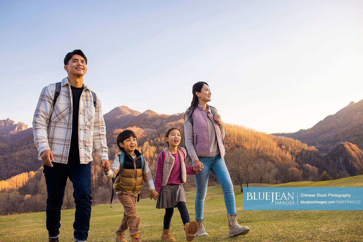 Happy young Chinese family having fun outdoors