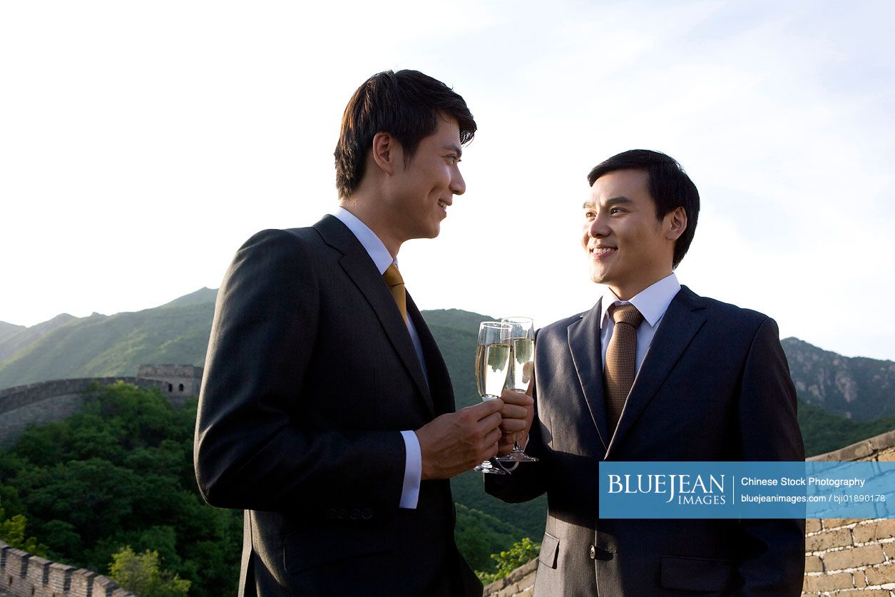Chinese businessmen having champagne on the Great Wall