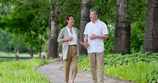 Happy senior Chinese couple walking in park,4K