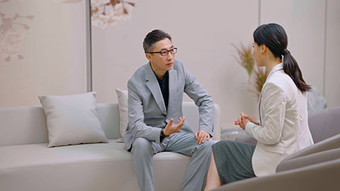 Confident Chinese business people talking in meeting room