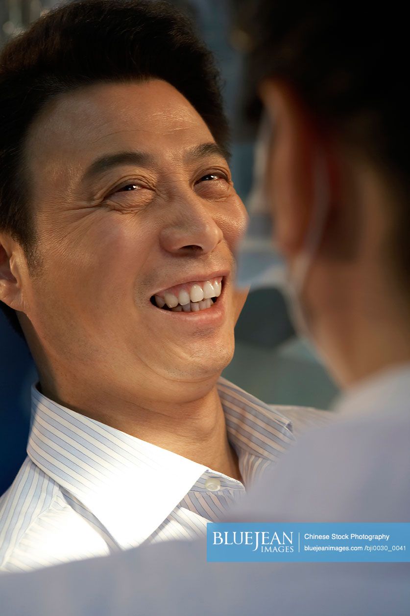Chinese man looking at teeth X-rays