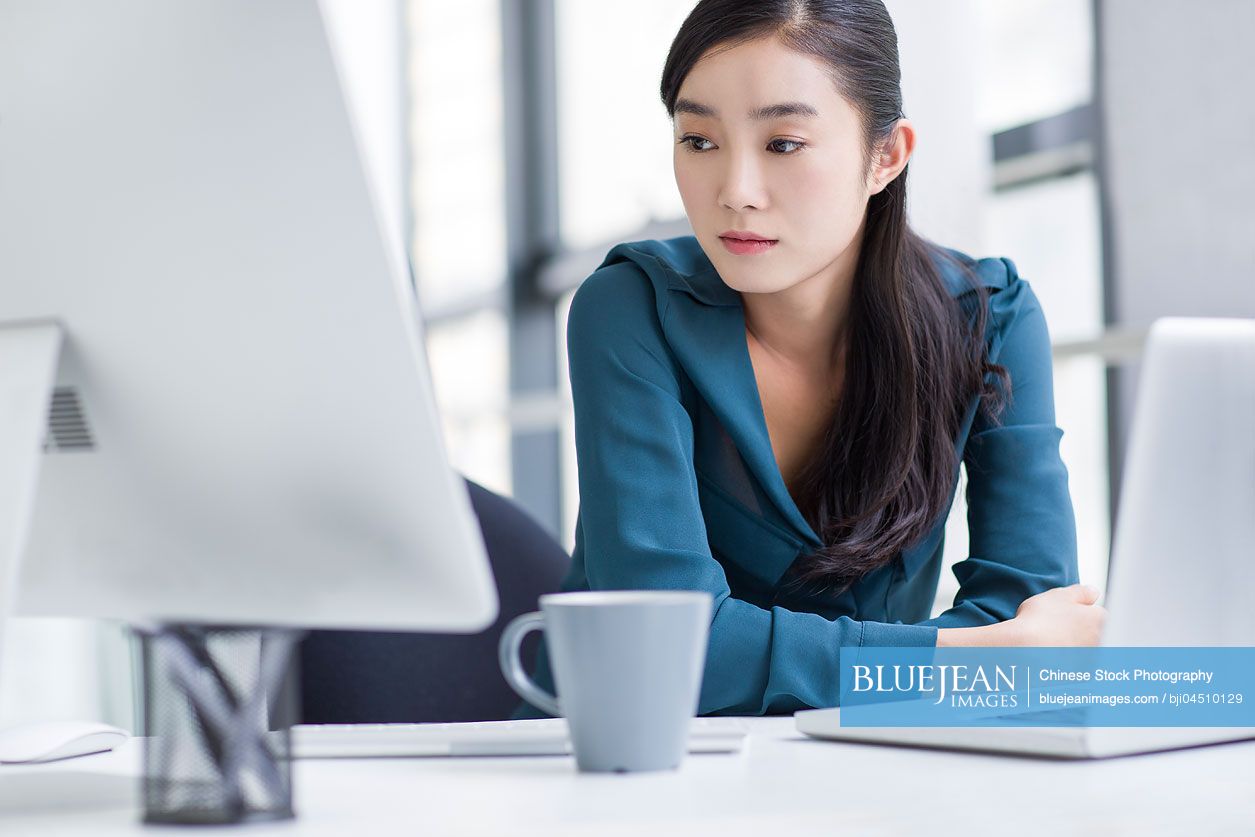 Young Chinese businesswoman working in office