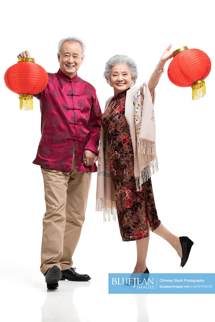 happy-senior-chinese-couple-celebrating-chinese-new-year-high-res-stock