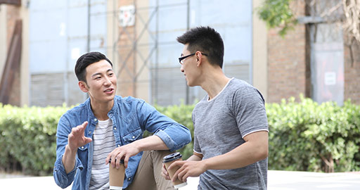 Young Chinese men drinking coffee outdoors,4k