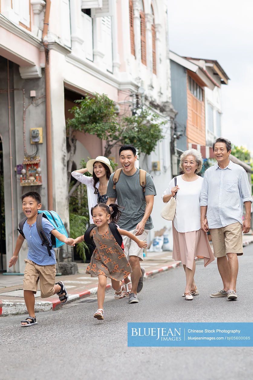 Happy family enjoying vacation on street