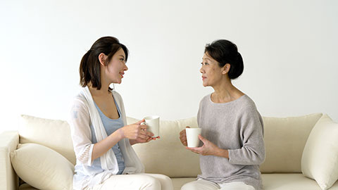 Chinese mother and daughter relaxing on sofa,4K