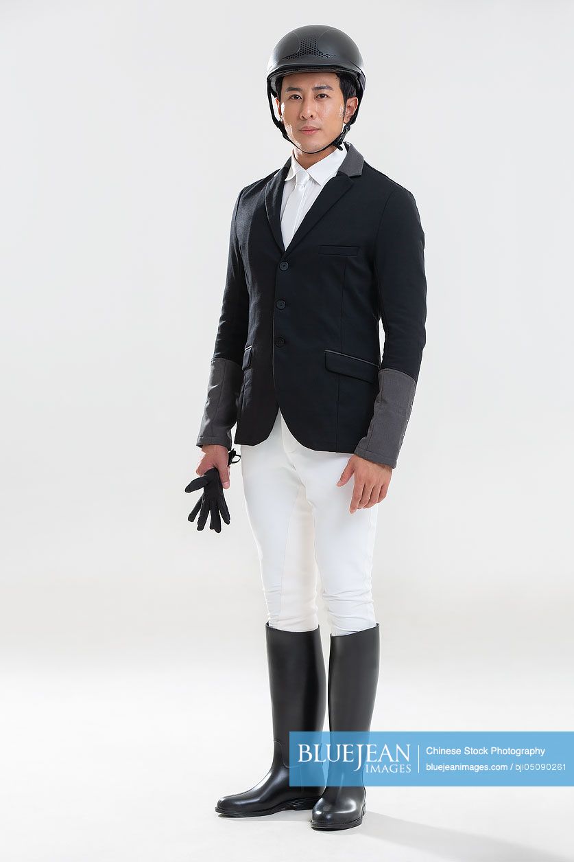 Young Chinese man in riding clothes