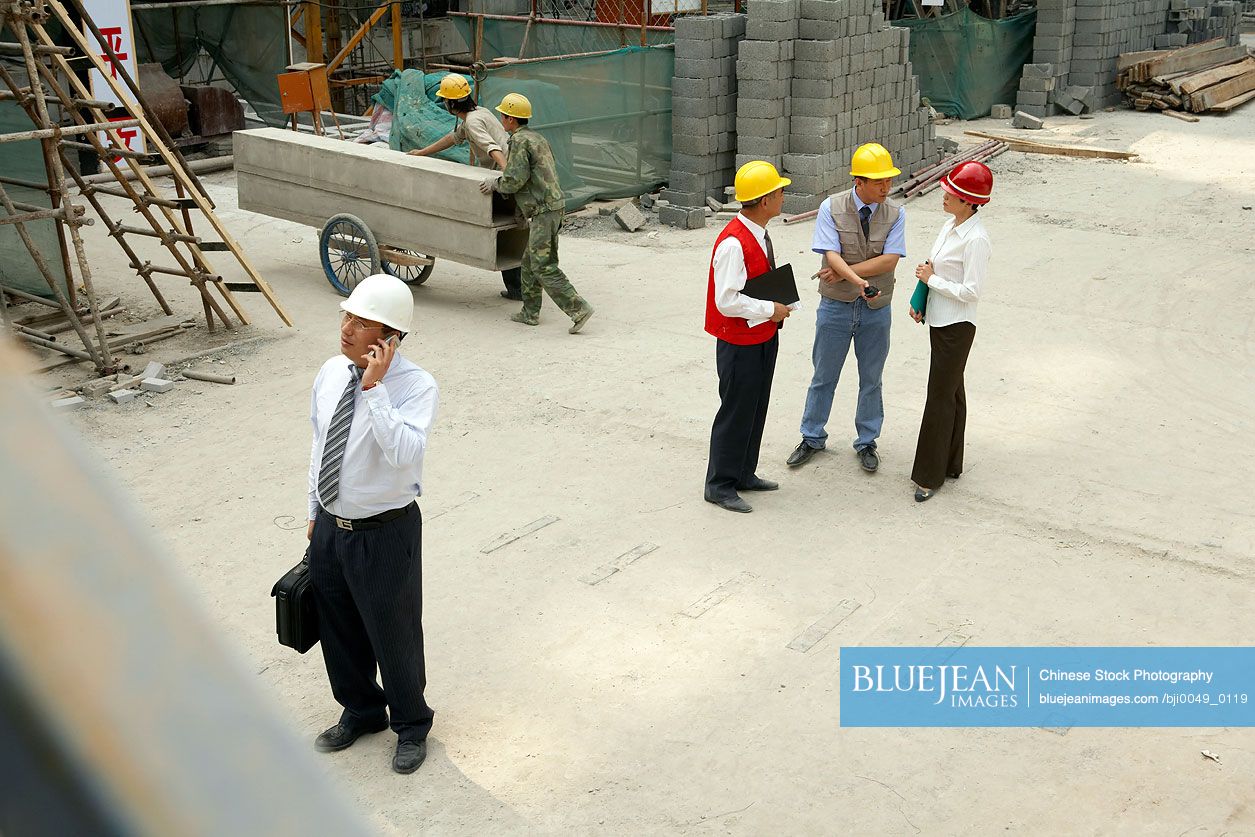 Chinese Construction Contractor Talking On Cellphone