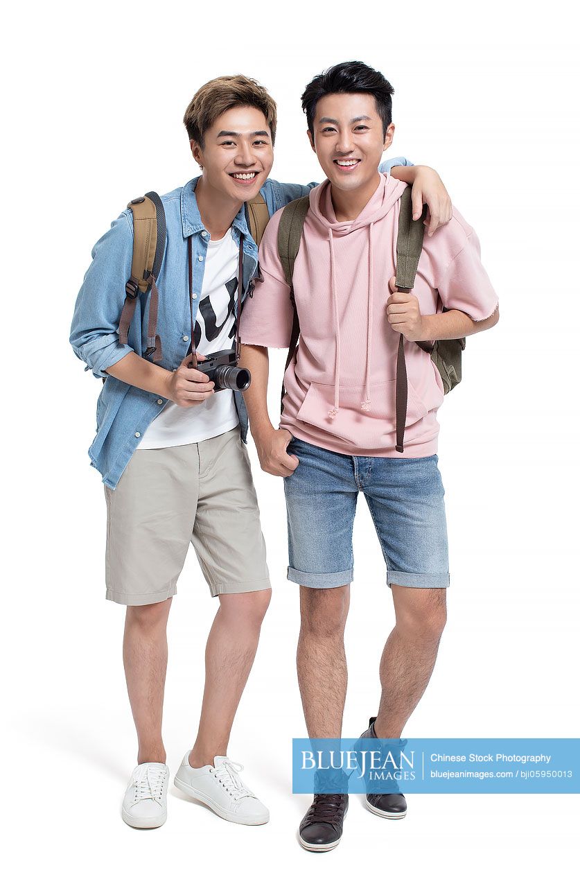 Happy young Chinese friends travelling together
