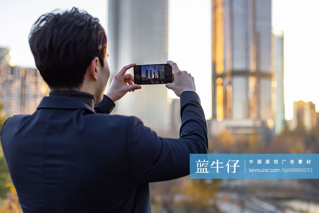 商务男子在户外用手机拍照