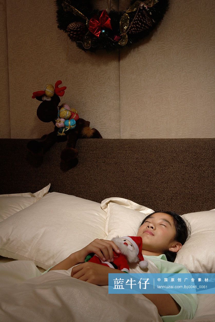 小女孩抱着圣诞老人娃娃睡觉