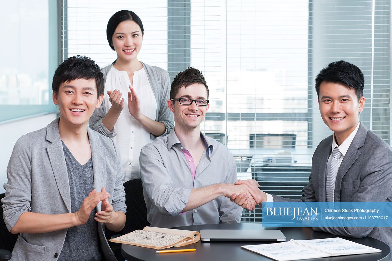 Business persons shaking hands for cooperation