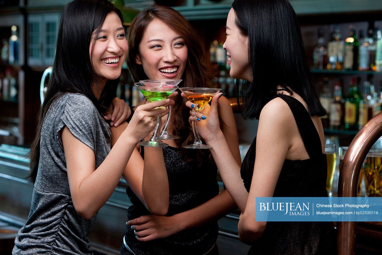 Chinese friends relaxing at a bar