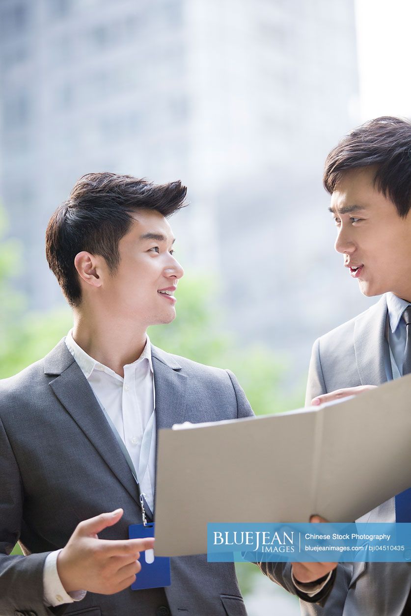 Young Chinese business person working outdoors