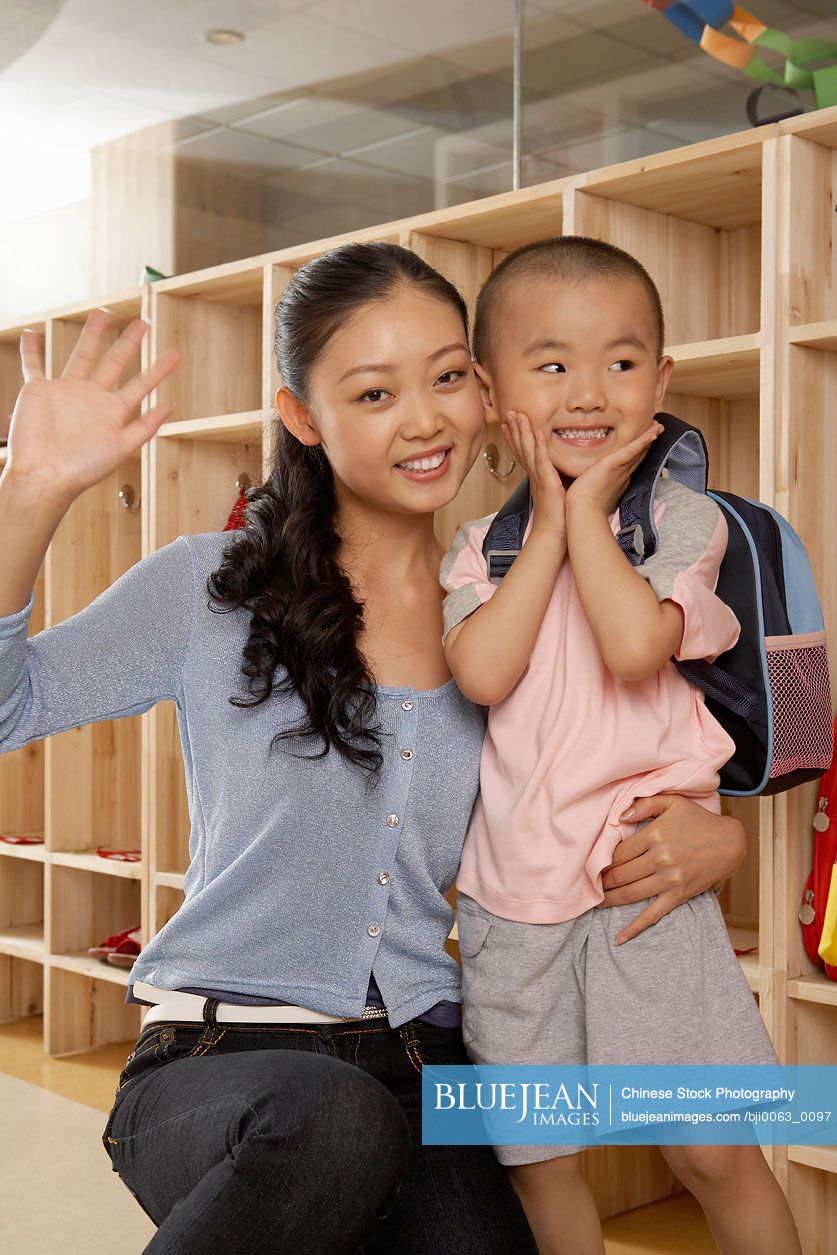 Chinese Teacher Hugging Boy At School