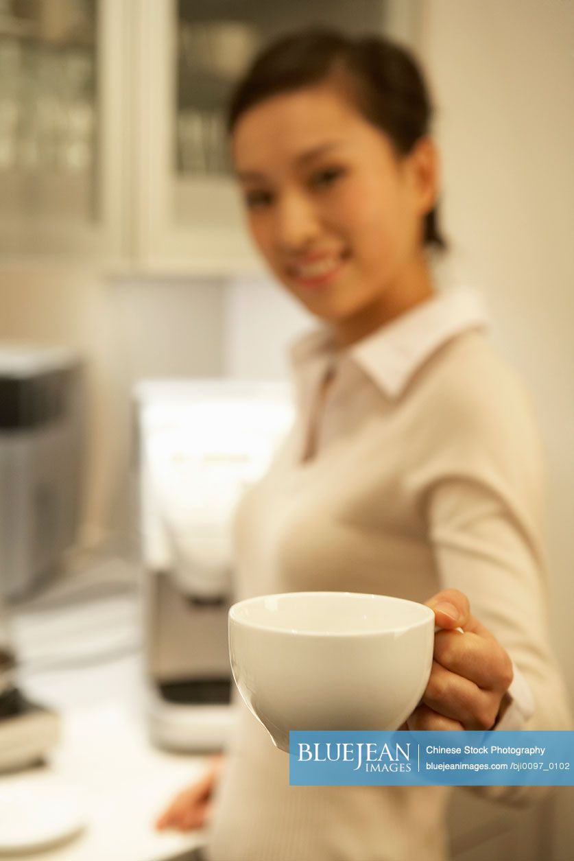 Chinese Young Woman Holding Coffee Cup