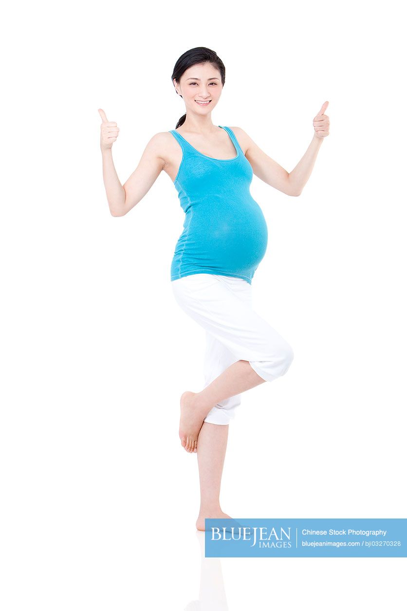 Chinese pregnant woman doing thumbs up