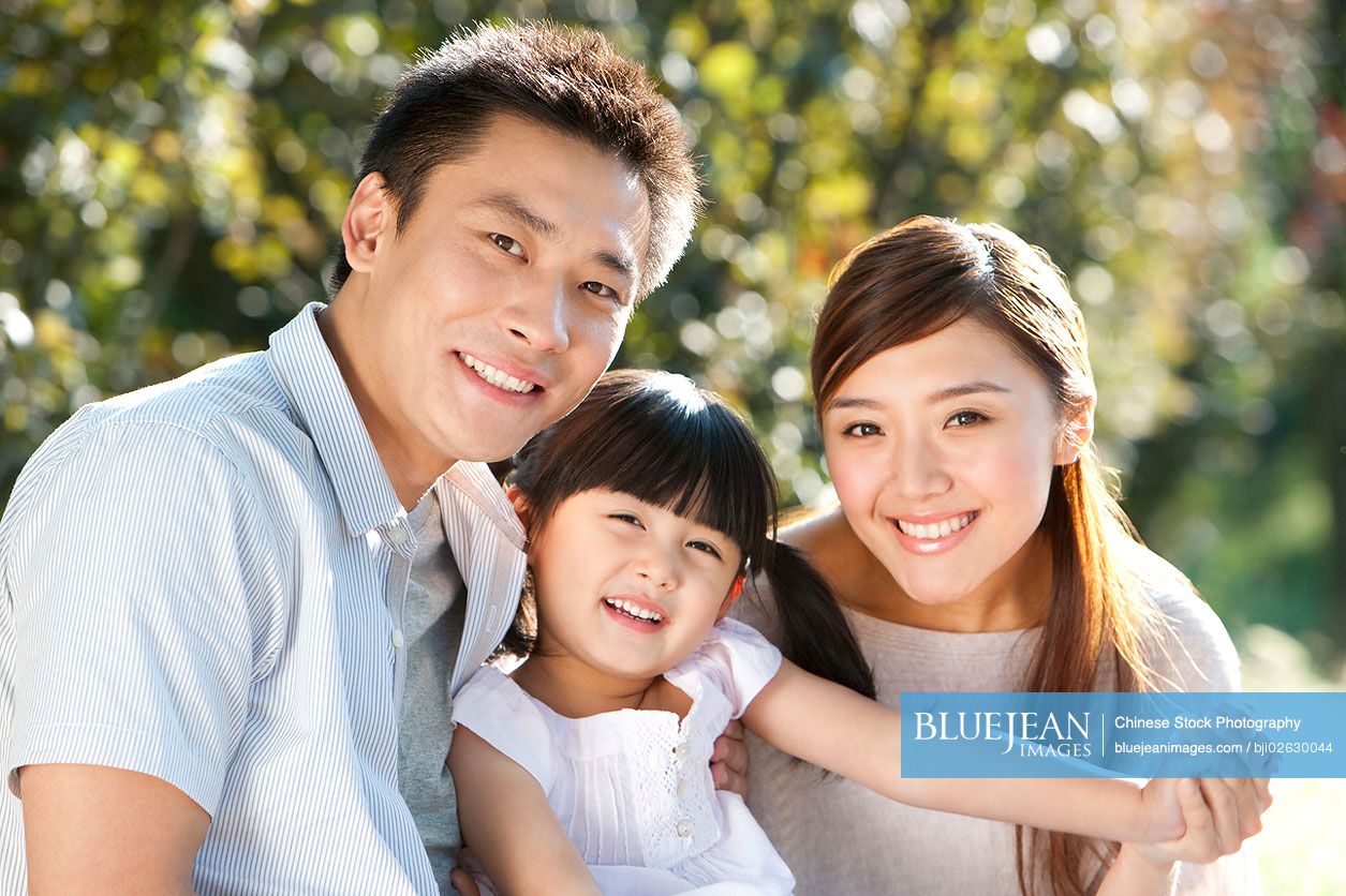 Young Chinese family portrait outdoors