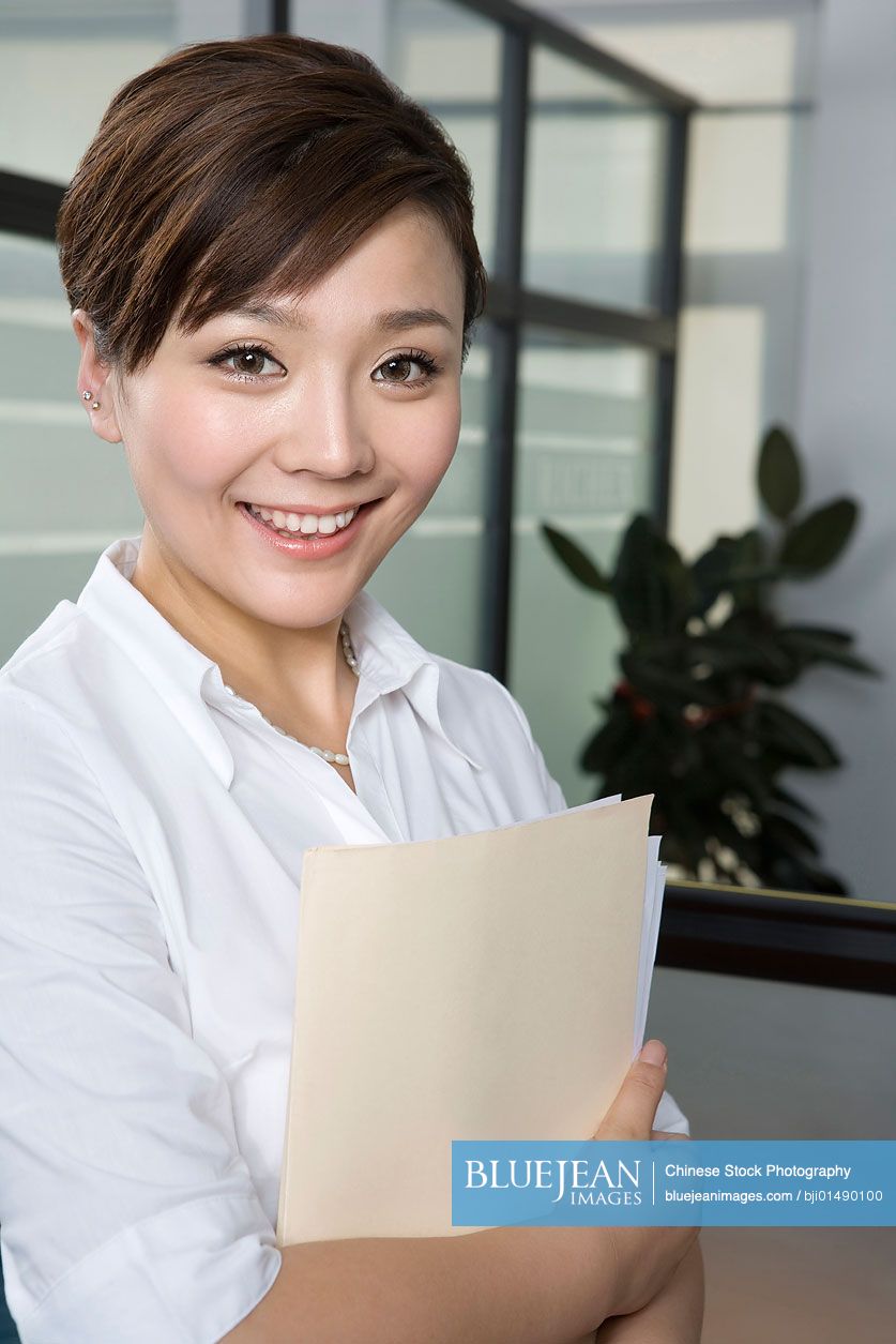 Chinese office worker holding a folder