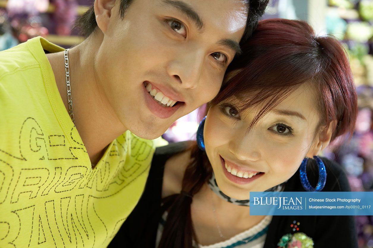 Young Chinese couple smiling and looking at camera