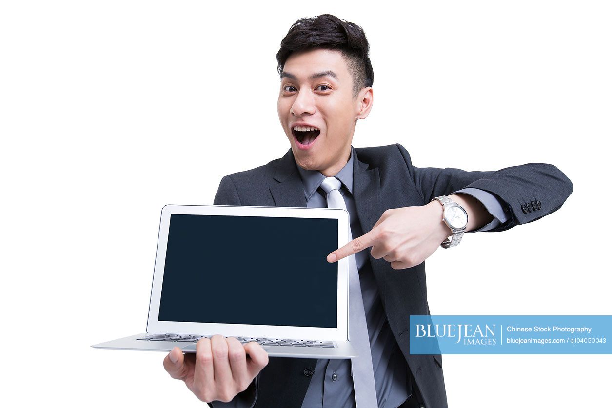 Young Chinese businessman with laptop