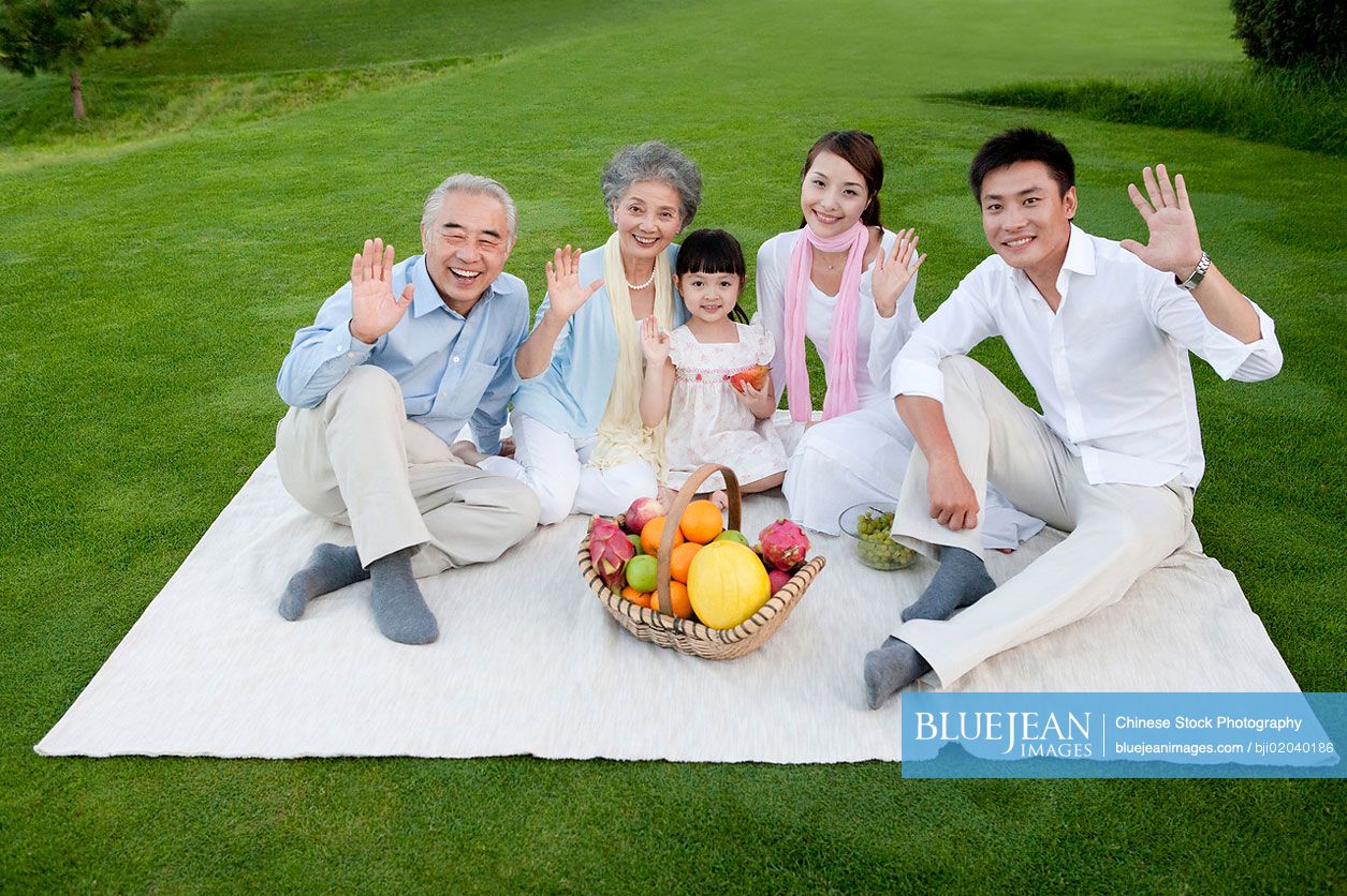 Big Chinese family enjoying a picnic in the park