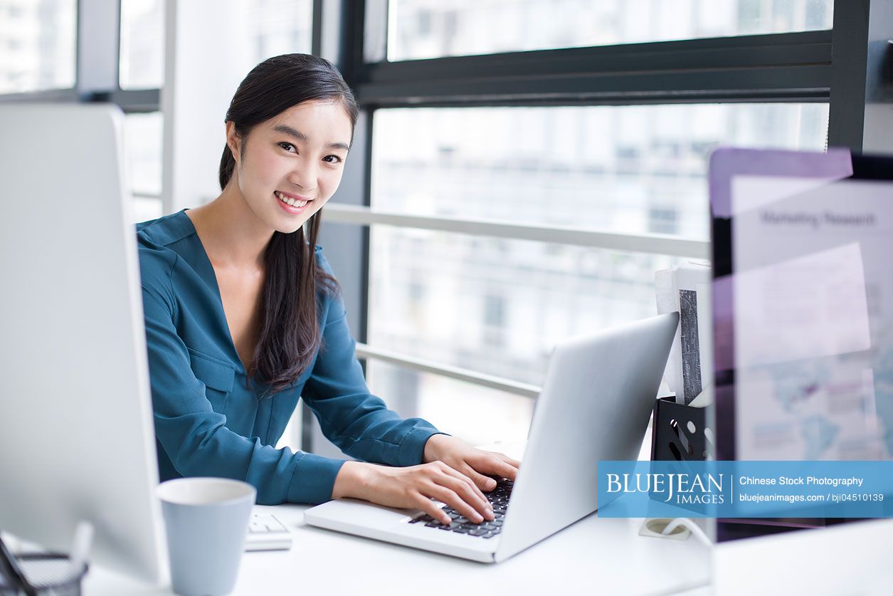 Young Chinese businesswoman working in office