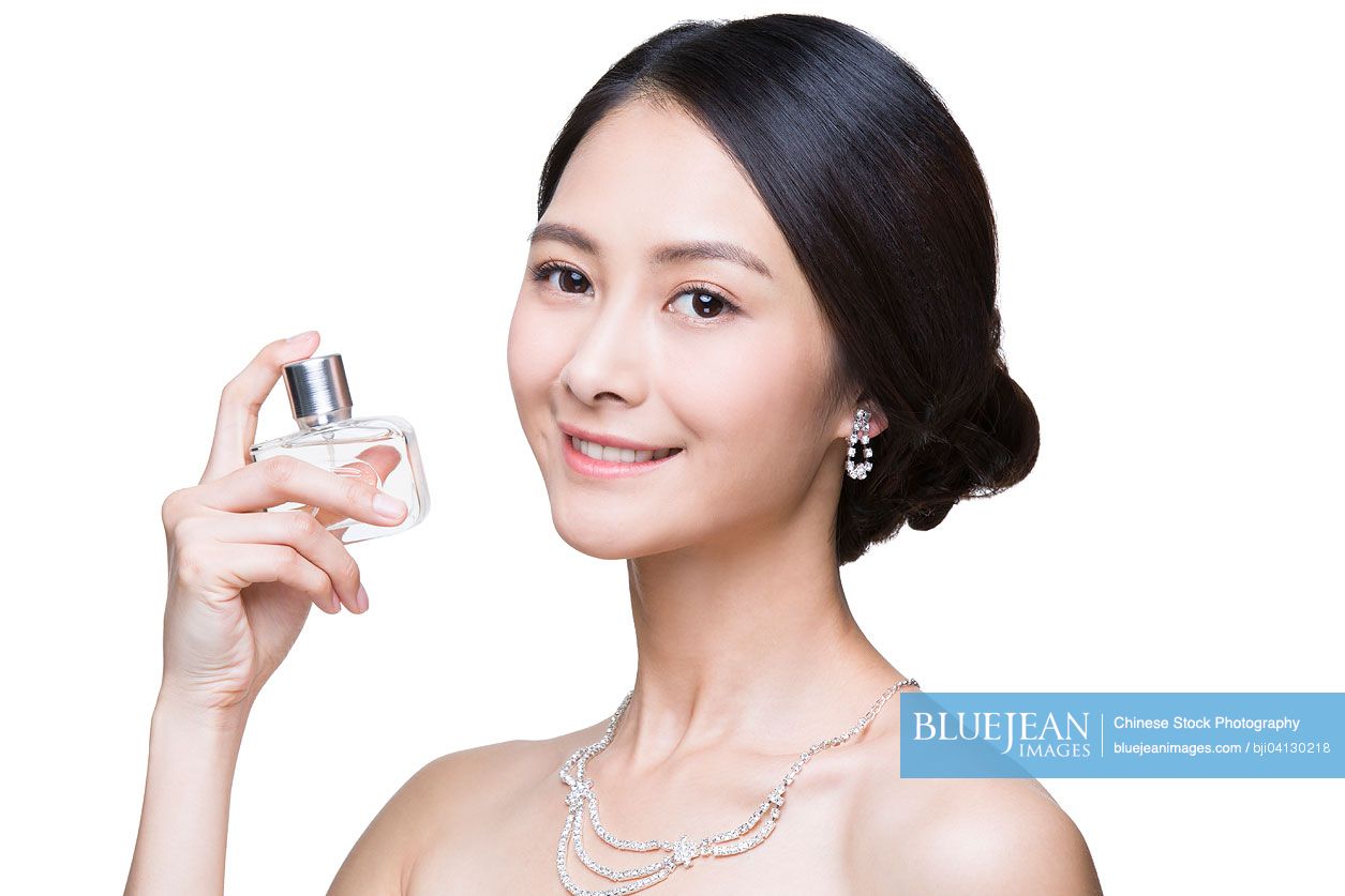 Beautiful young Chinese woman with perfume