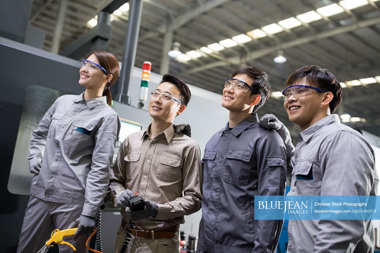Confident Chinese engineers in the factory