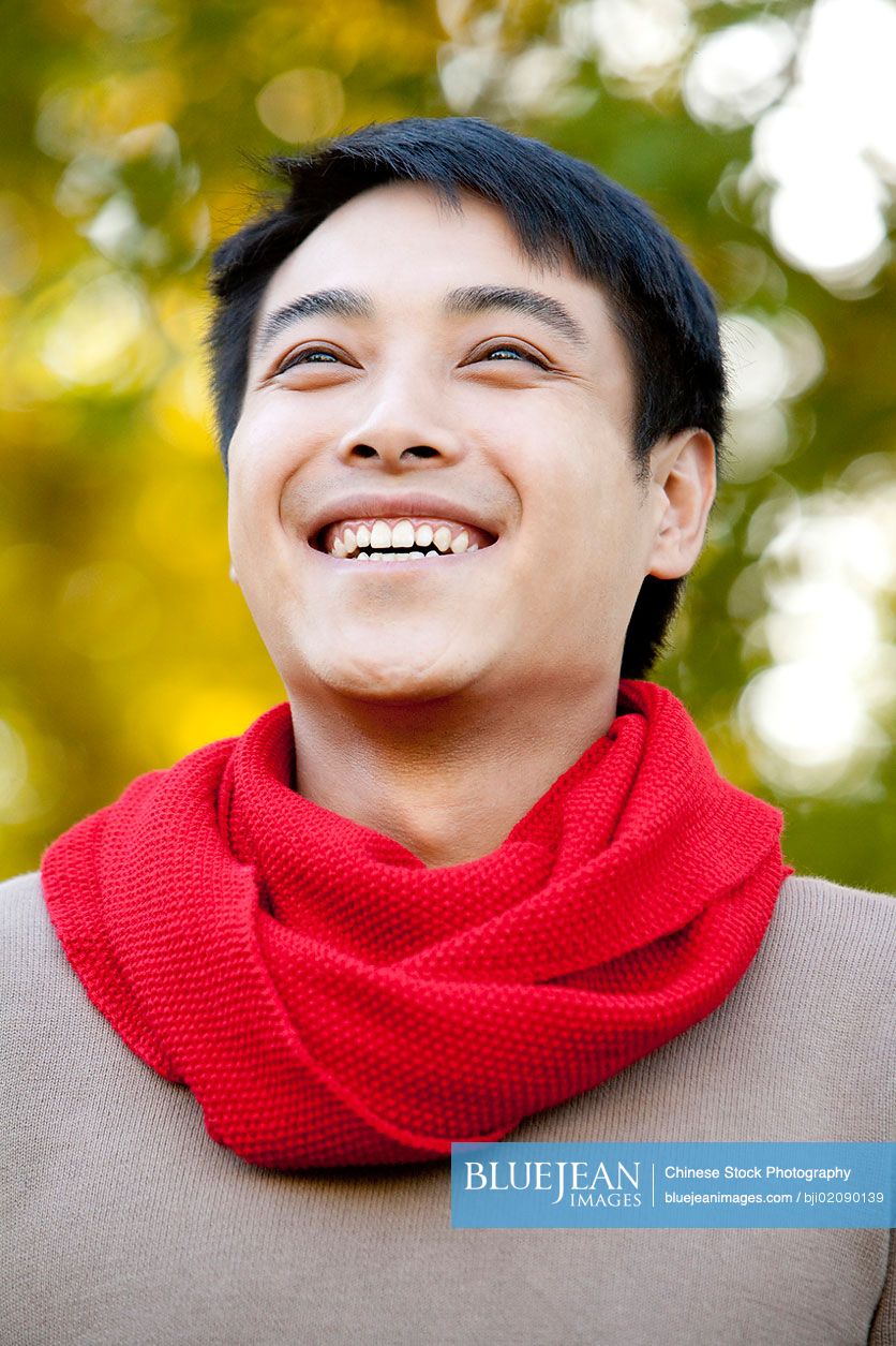 Young Chinese man in a park in autumn