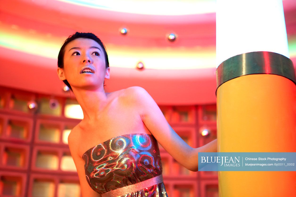 Chinese Woman Peeking Around Futuristic Lamp